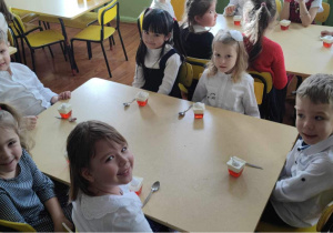 Dzieci degustują sernik w barwach czerwieni i bieli