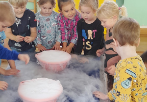 Dzieci oglądają bańki mydlane powstające z suchego lodu