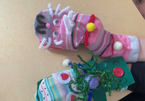 Na stole leżą dwie kolorowe skarpetkowe pacynki